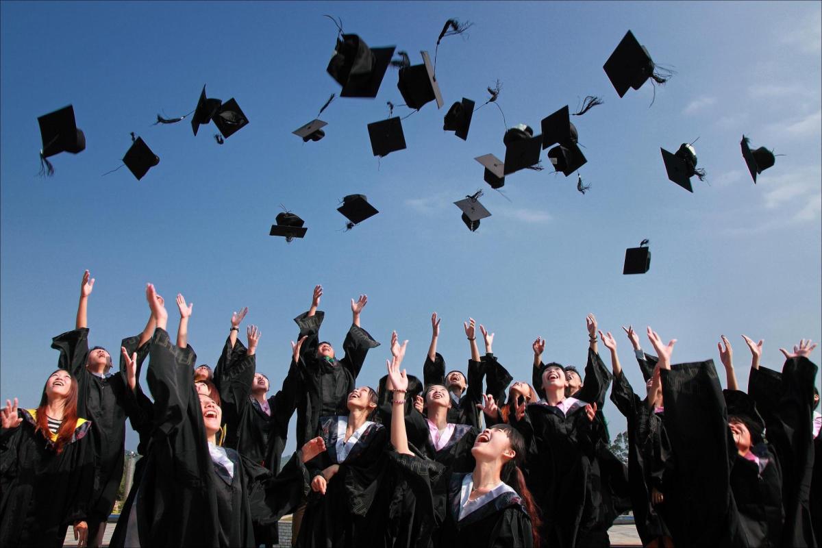 Graduates toss their caps in the air