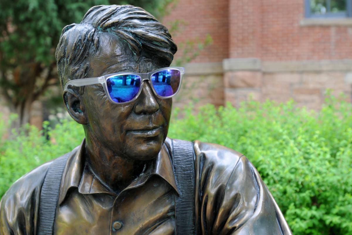 Robert Frost statue wearing sunglasses