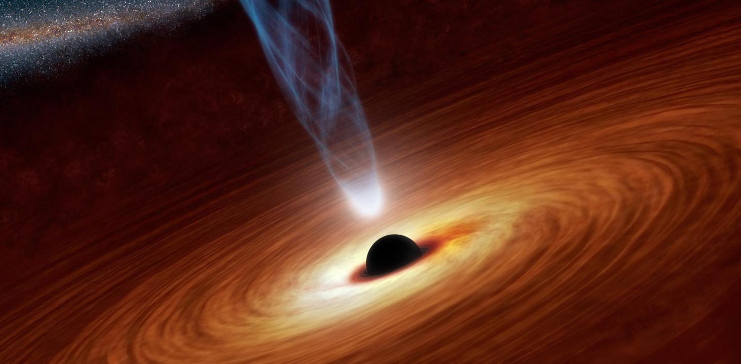 Matter swirls around a central black hole as it emits a bright jet