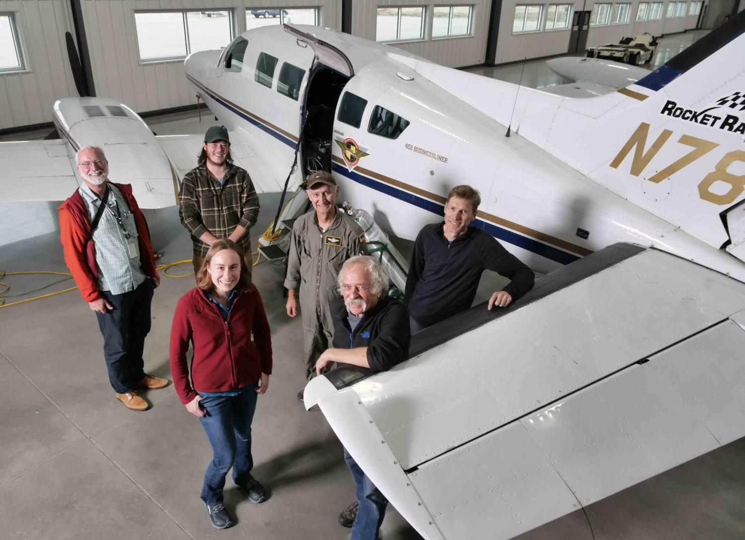 Members of INSTAAR, the University of Maryland and TOFWERK group photo in a hangar