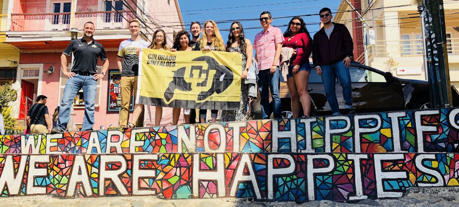 Students pose for photo in Chile with Buff flag