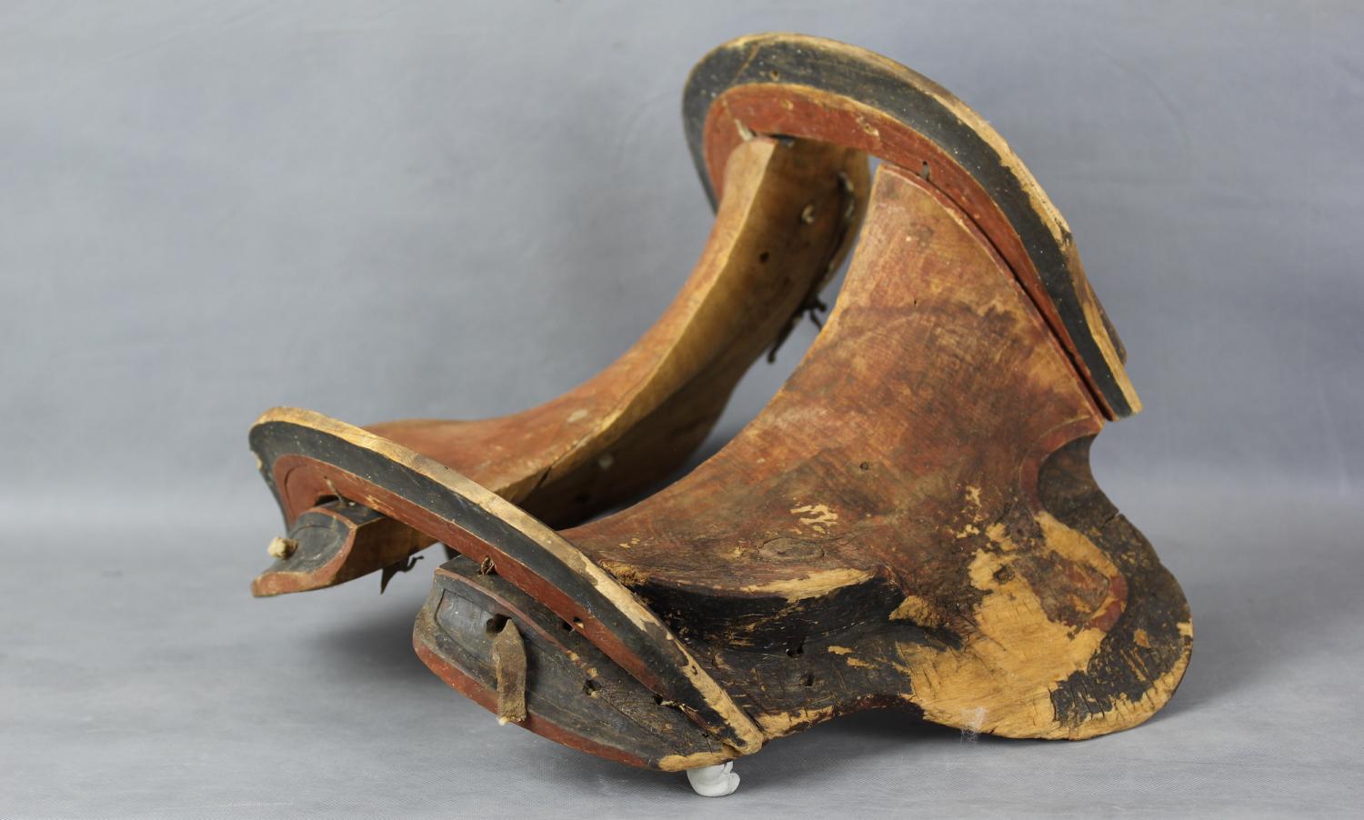 Photo of an ancient saddle made of wood