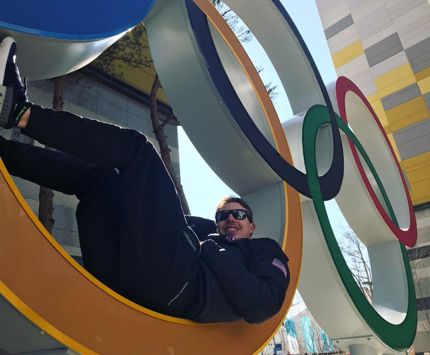Brian Hansen sits in the Olympic rings