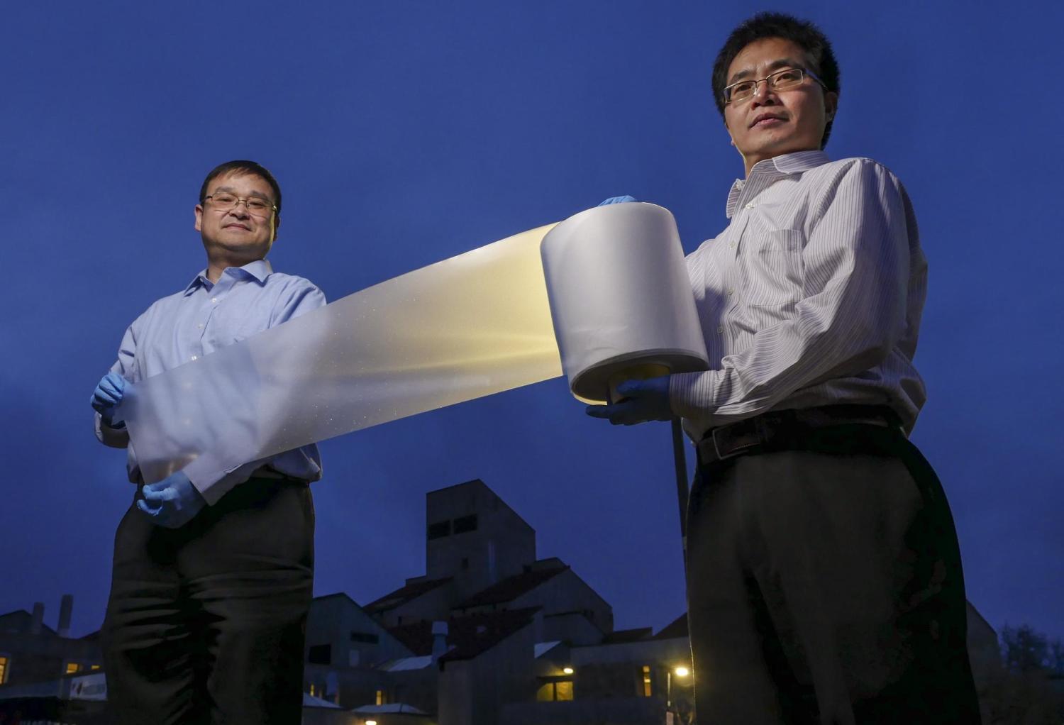 researchers with cooling material on a roll