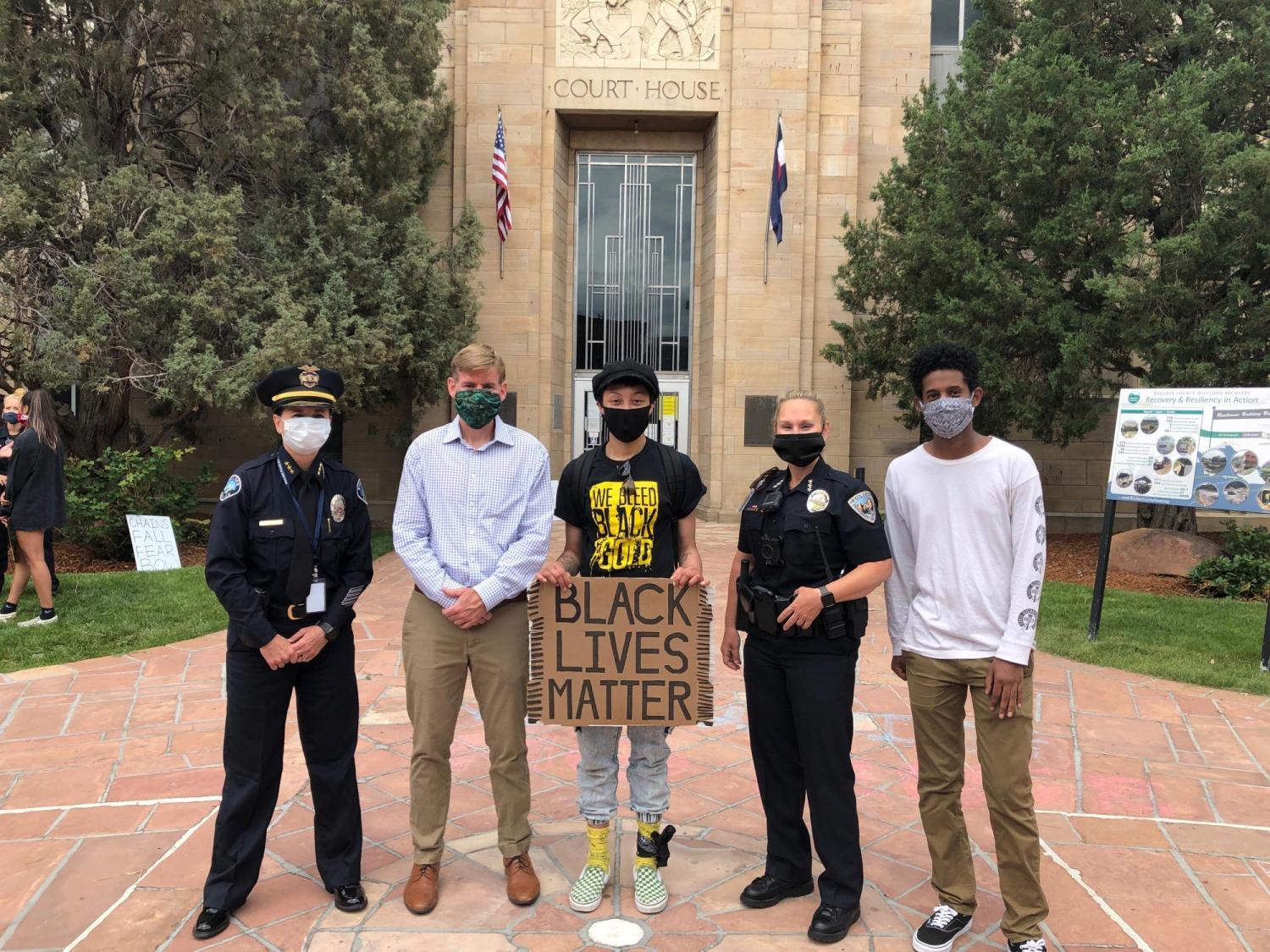 CU Police Chief Doreen Jokerst and other area law enforcement officials take a photo with students during Black Lives Matter march