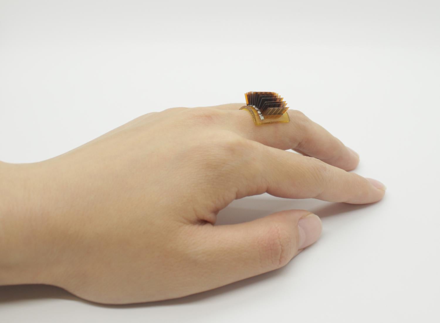 Hand with a thermoelectric wearable device worn like a ring