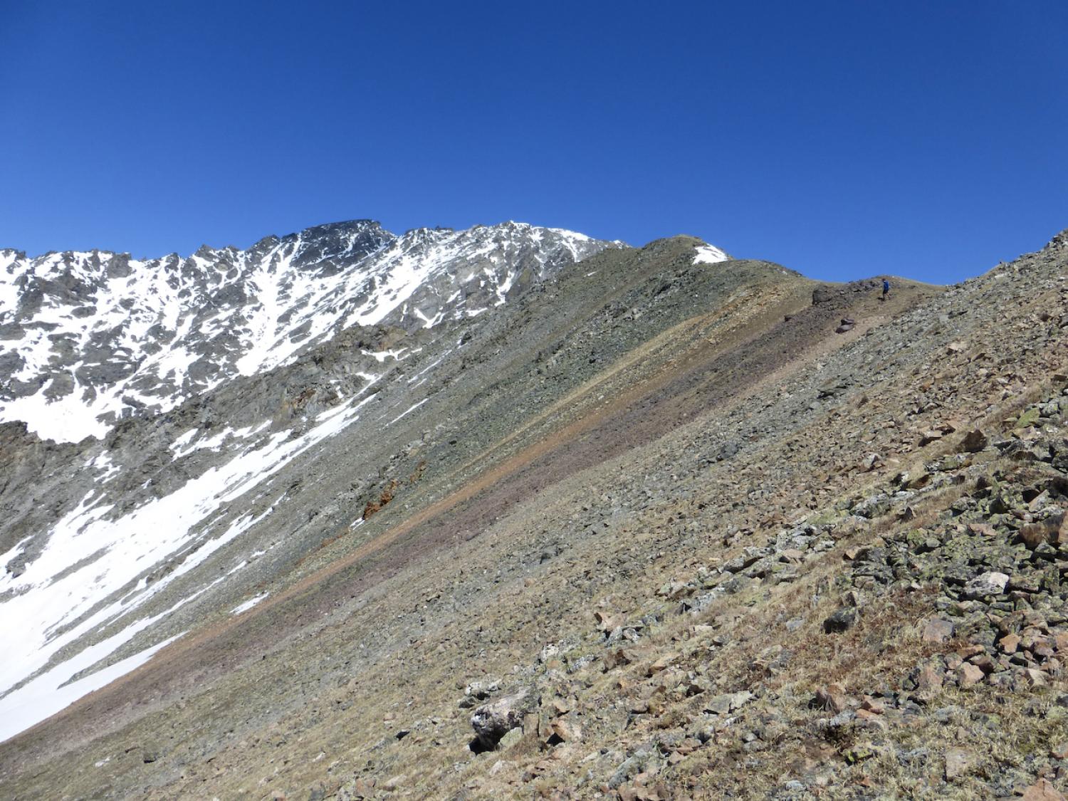 Scree covers a steep slope along a mountain pass