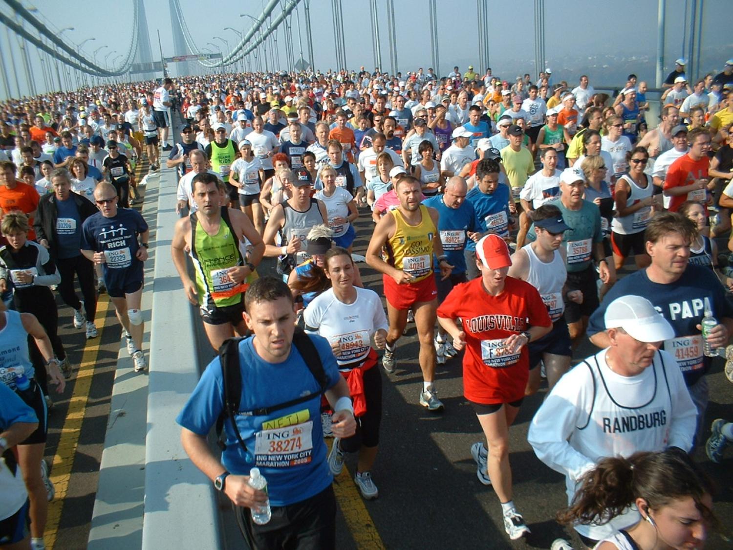 Thousands of people run across a bridge