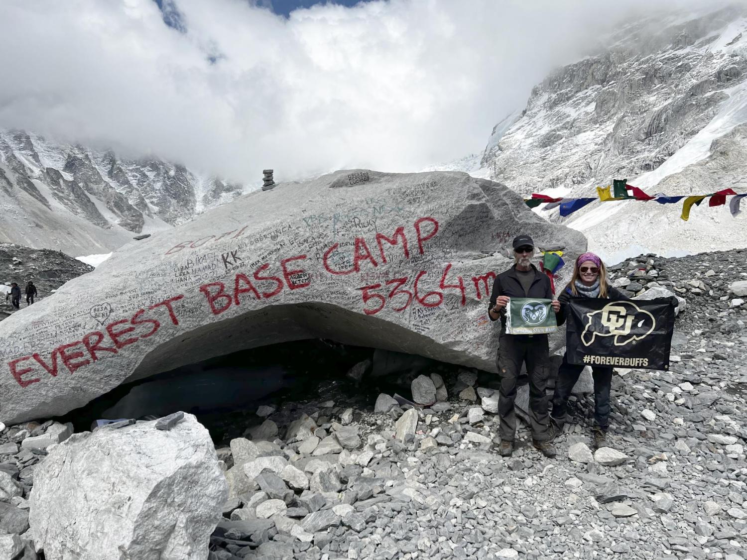 Joel Berger and Joanna Lambert hold CSU and CU Boulder flags at Everest base camp
