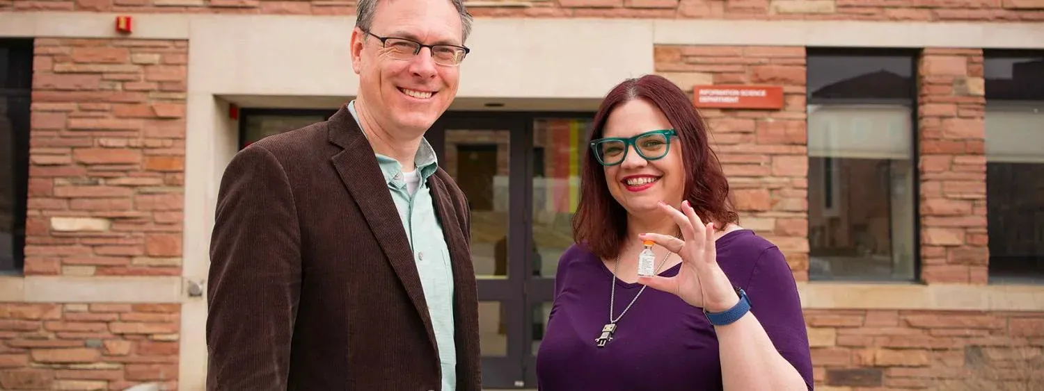 Casey Fiesler, holding an insulin vial, standing next to Steven Vvoida