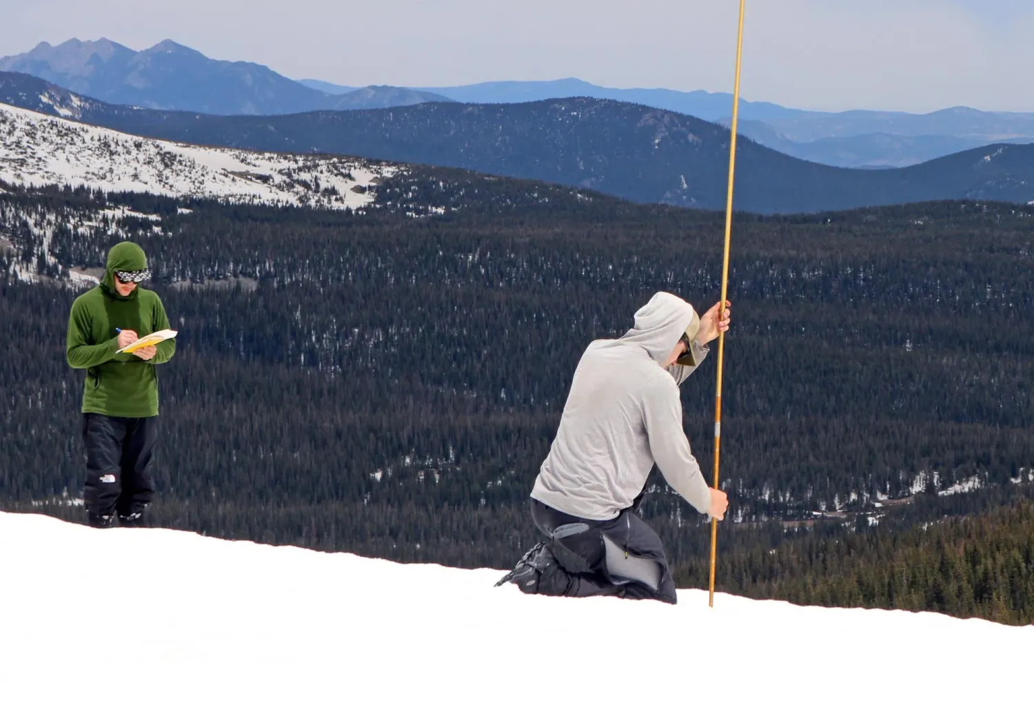 Researchers work on a steep mountain slope
