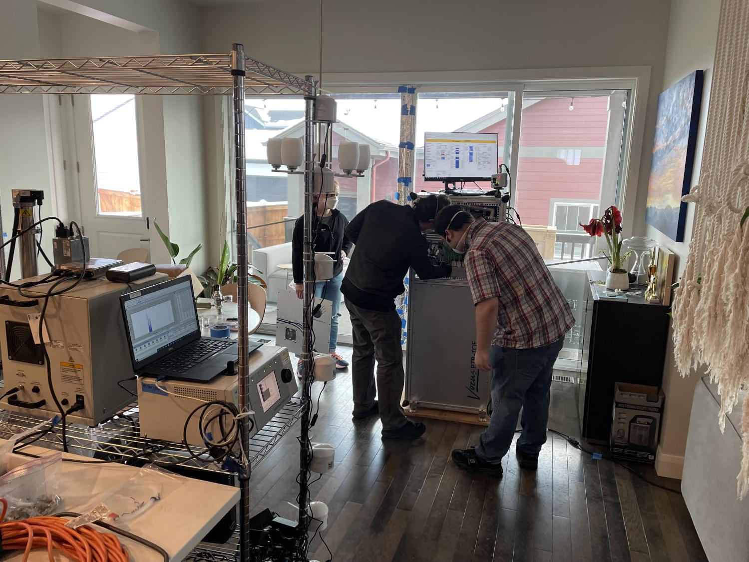 Scientists test air quality inside a surviving home. Above, a car and a chimney are all that remains of homes that burned.