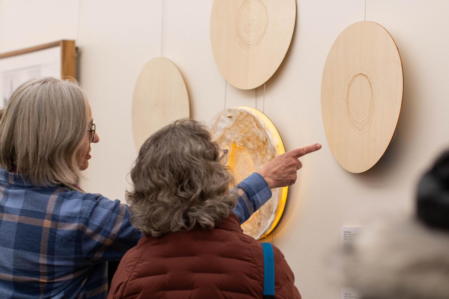 community members examine artwork