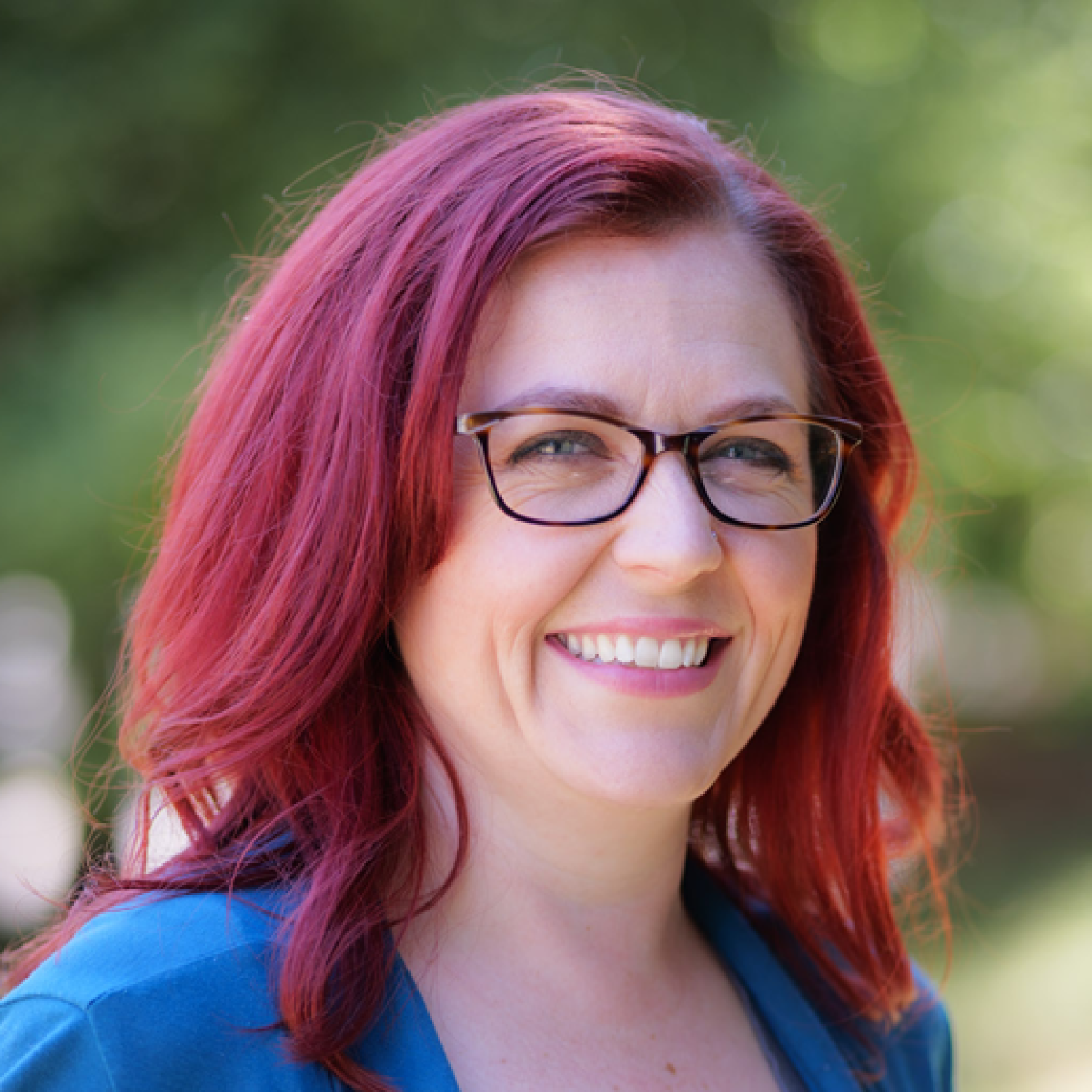 Woman with red hair smiling at camera
