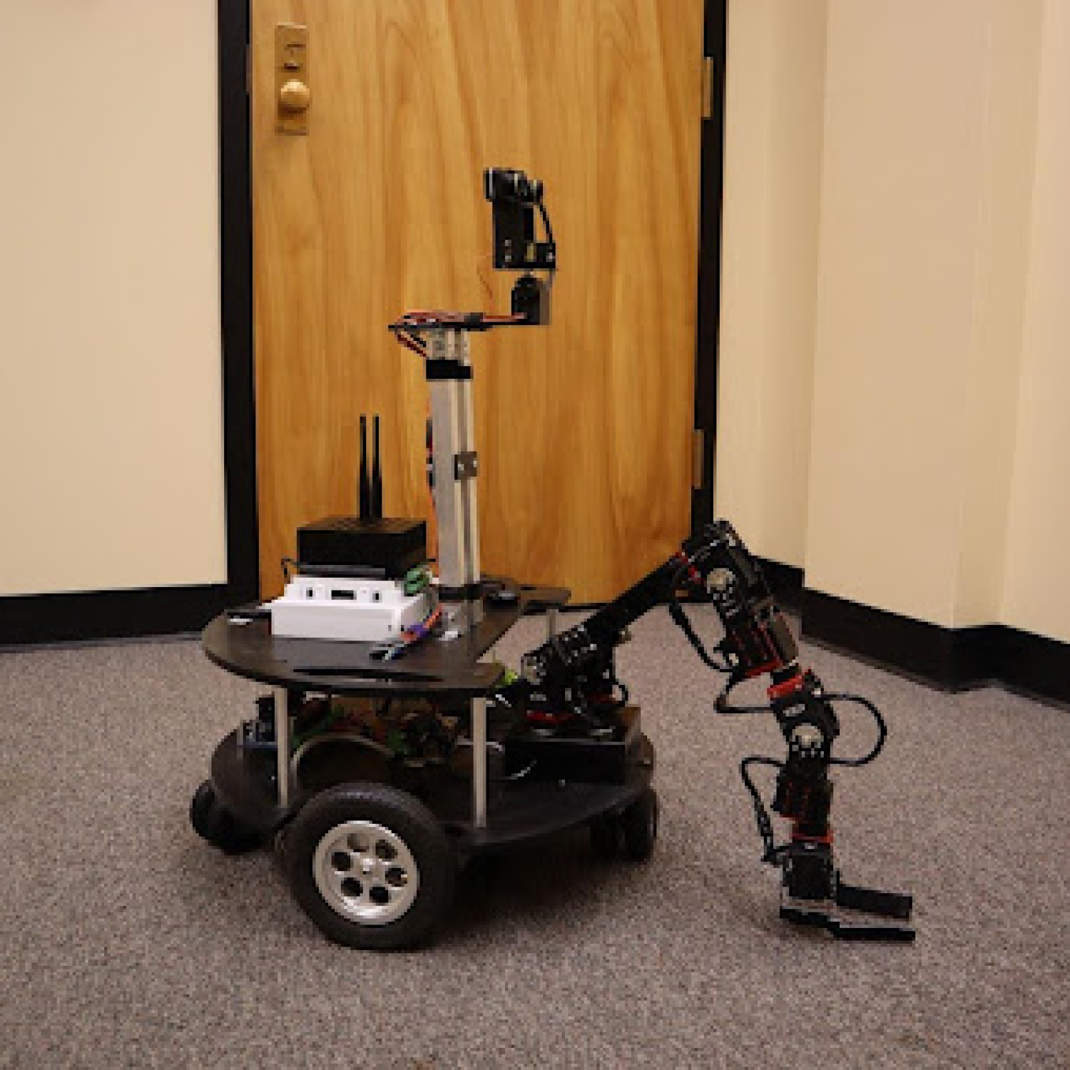 Robot with a long arm in an office