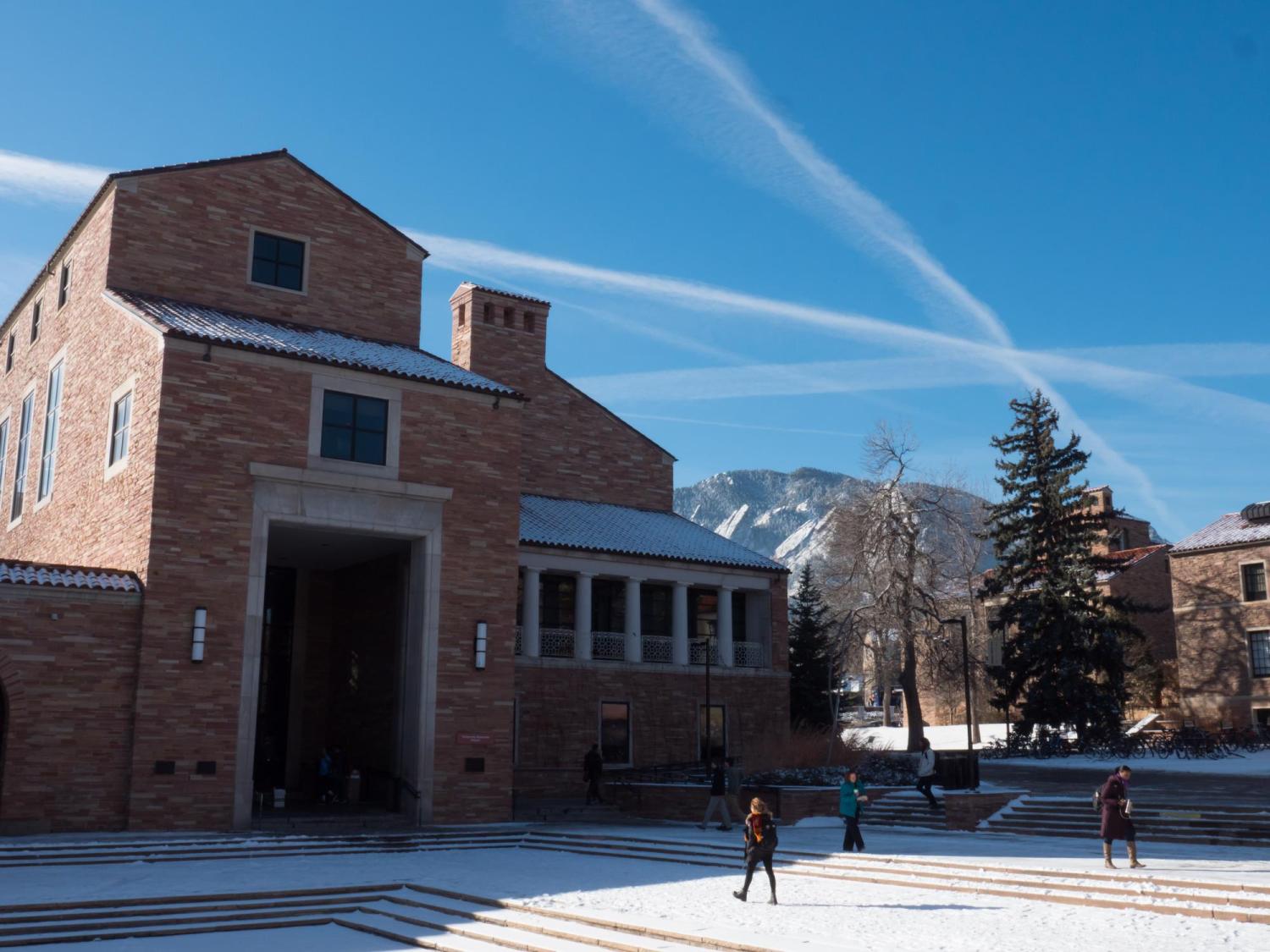 Students walk across a snowy campus
