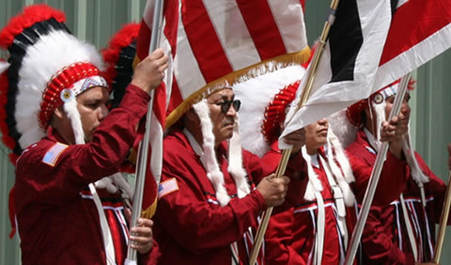 Arapaho chiefs at a gathering wearing headdresses