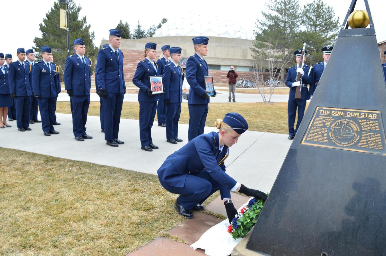 Air Force ROTC cadet leaves rose at shuttle memorial