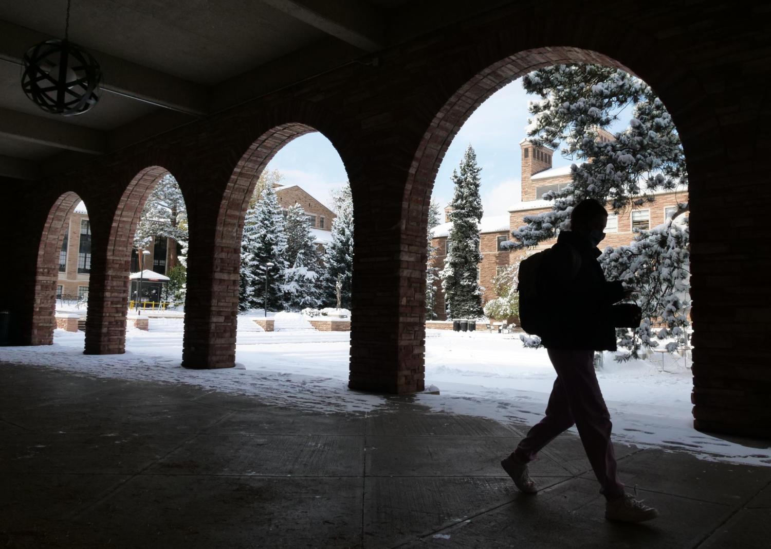 person walking on snowy campus