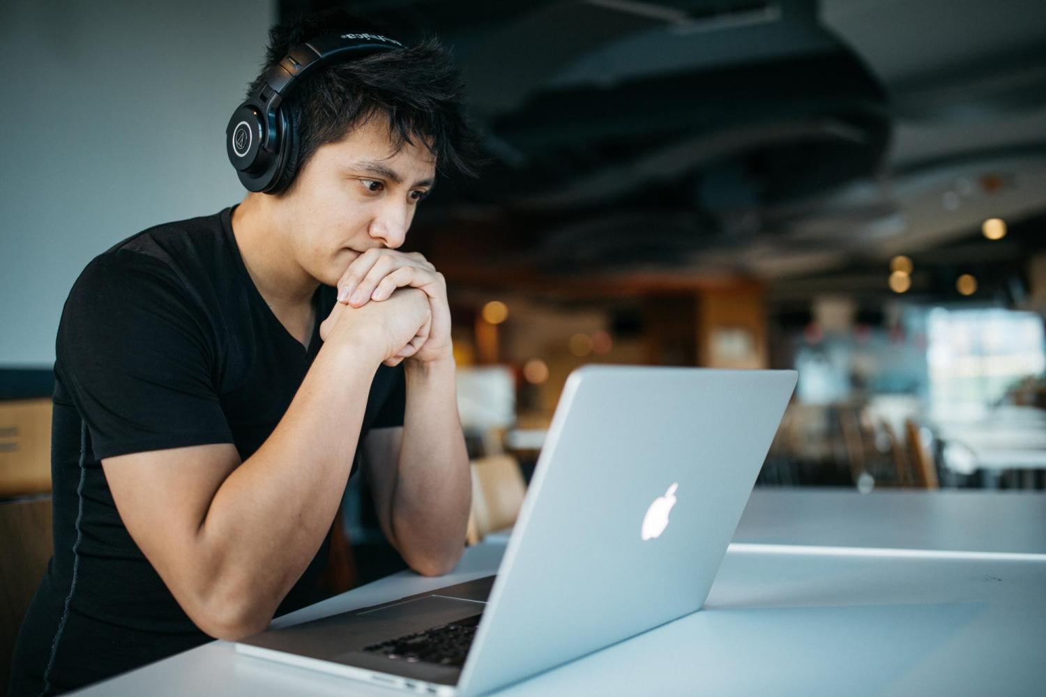 Person watching video on a laptop