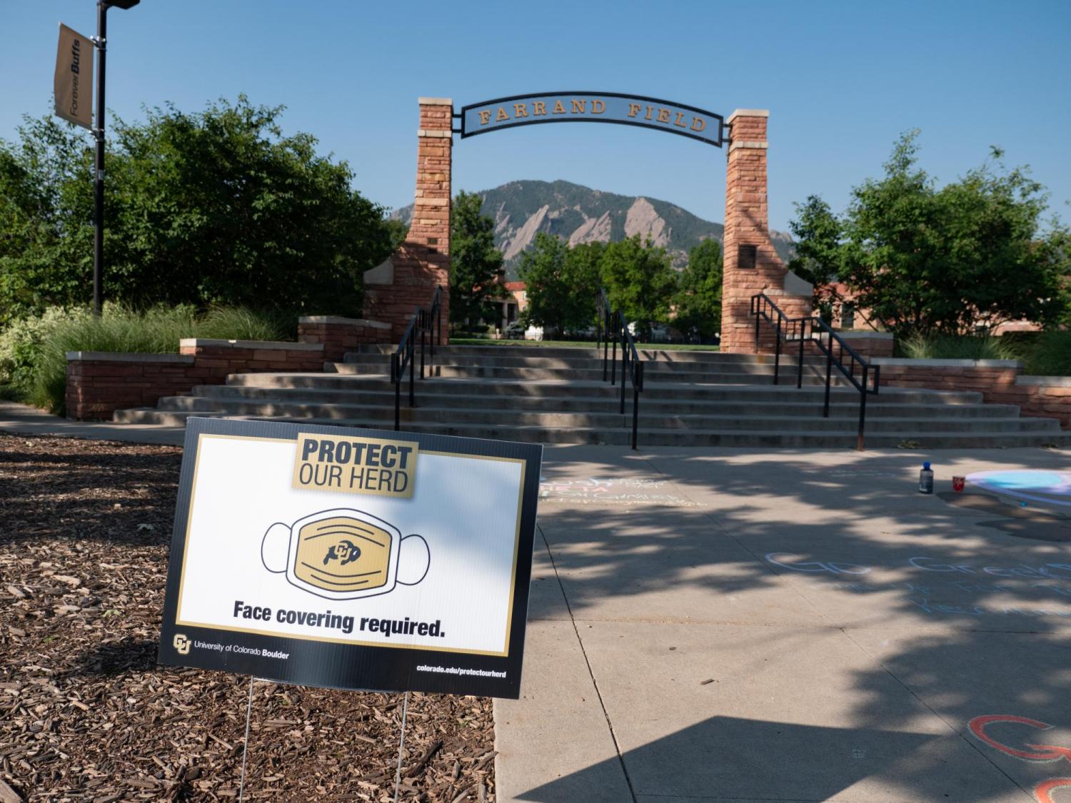 A Protect Our Herd–face covering required sign at the entrance of Farrand Field