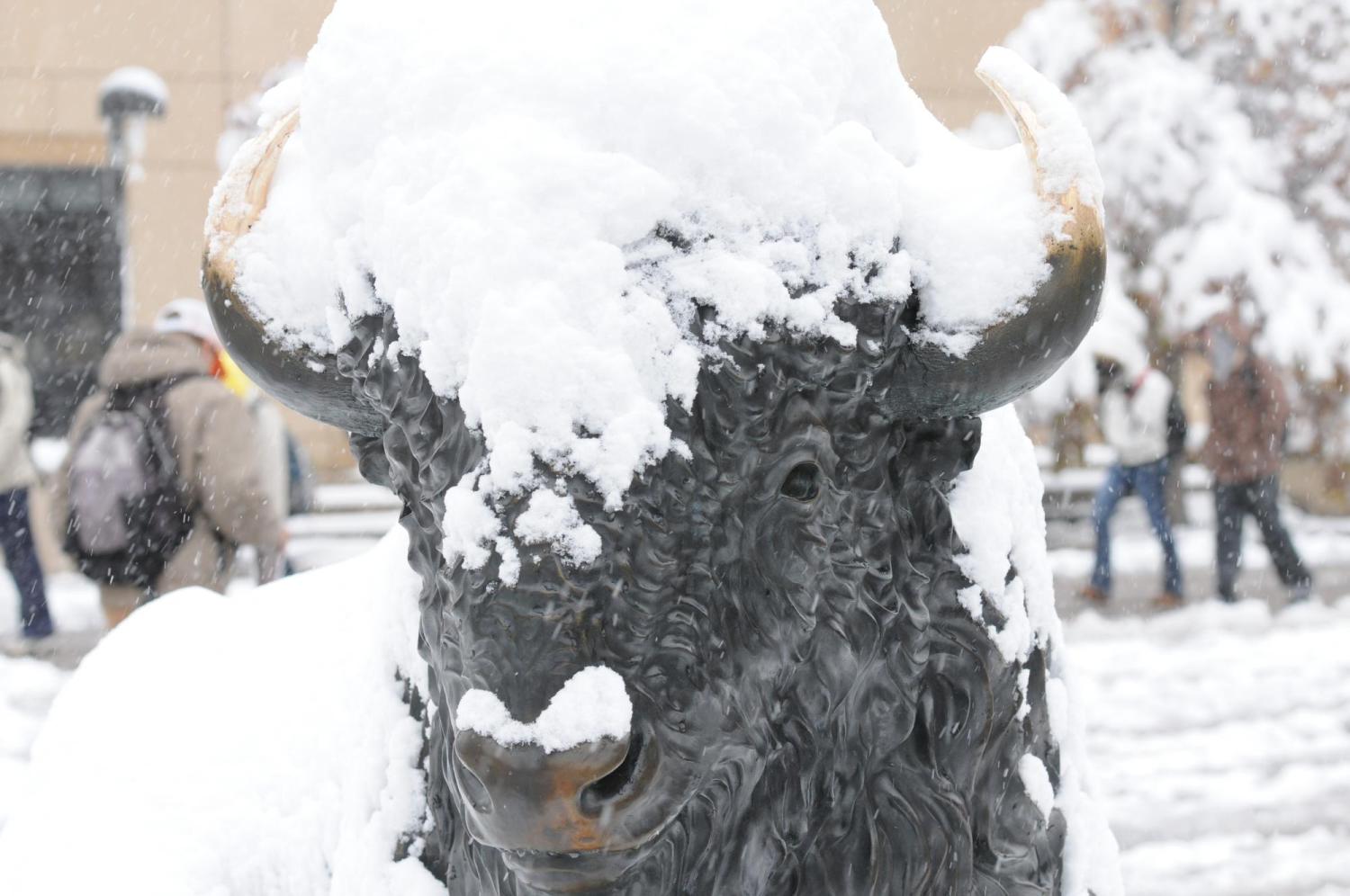 Snow settles on a statue of a Buffalo