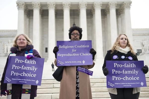 Demonstrators stand outside the Supreme Court in 2014