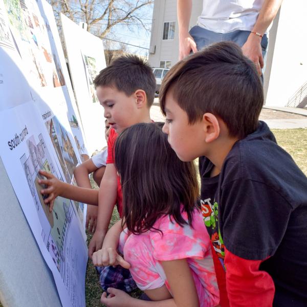 Children examine plans for the playground in their Denver neighborhood