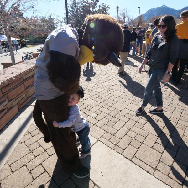 Chip greets a young fan during Homecoming weekend on the CU Boulder campus on Saturday, Nov. 9, 2019. (Photo by Glenn Asakawa/University of Colorado)