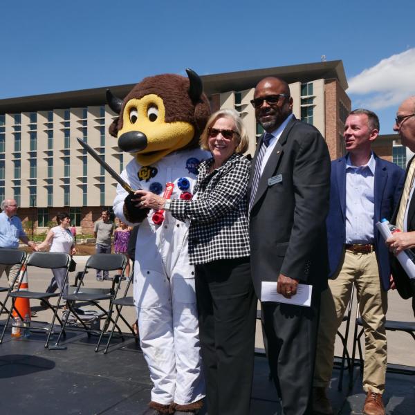 Ann Smead, center, and Brian Argrow, chair of the aerospace engineering department, right, pose with Chip following a ribbon-cutting ceremony at the new Aerospace Engineering Sciences Building at CU Boulder. (Photo by Glenn Asakawa/CU Boulder)