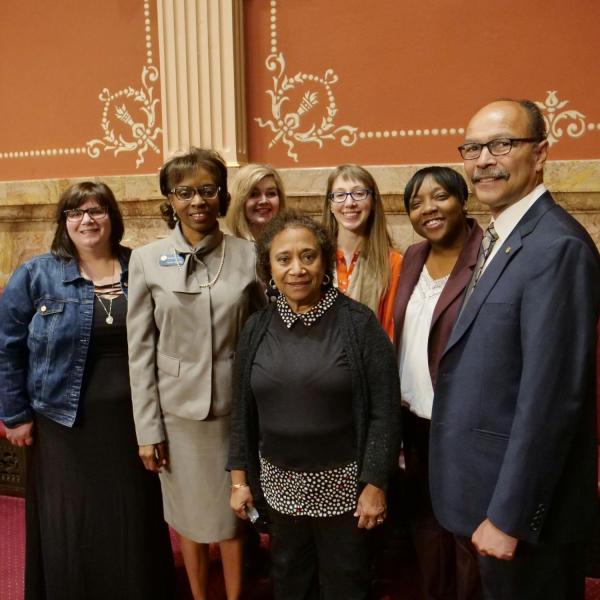 State Senator Rhonda Fields, standing next to CU faculty member Polly McLean, and other friends and genealogists pose for a group photo.