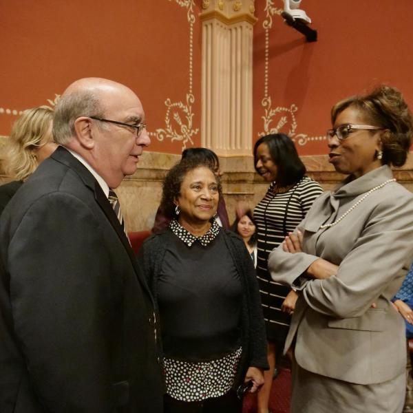 CU Boulder Chancellor Phil DiStefano, left, and professor Polly McLean, center, speak with State Senator Rhonda Fields.