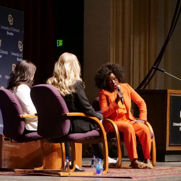 Ashley William (white coat) of Cultural Events Board and Ally Roberts of Distinguished Speakers Board ask Viola Davis questions on stage. Photo by Glenn Asakawa.