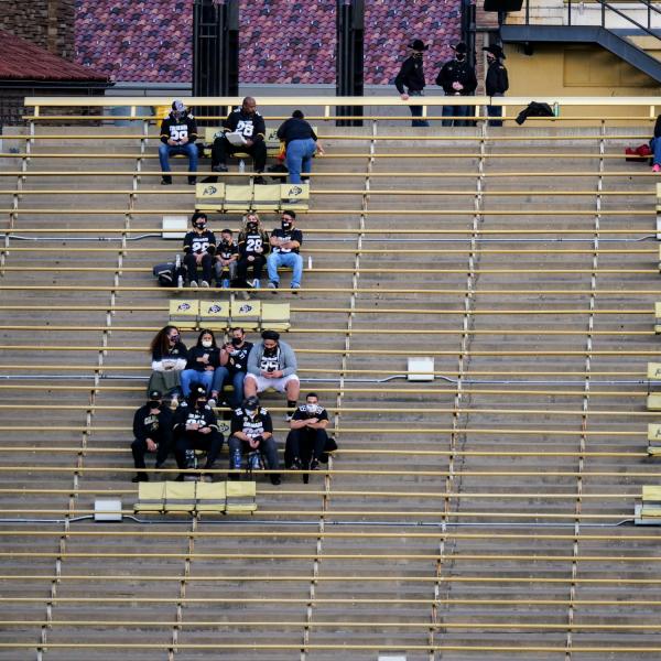 Attendees of the Colorado-UCLA game at Folsom Field sit socially distanced in the stands. (Photo by Glenn Asakawa/University of Colorado)