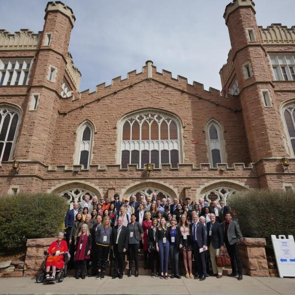 Group photo of Conference on World Affairs speakers and guests outside of Macky Auditorium. Photo by Glenn Asakawa.