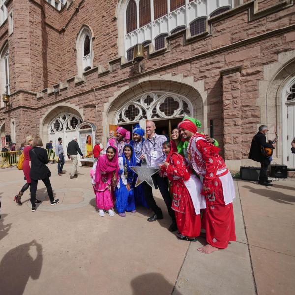 Colorado Bhangra team members have their photo taken outside of Macky Auditorium before the start of the Conference on World Affairs. The group danced as the processional made their way across the quad. Photo by Glenn Asakawa.