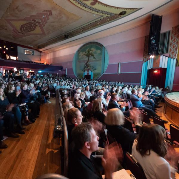 A packed house listens to pitches during the 2019 New Venture Challenge Finals at the Boulder Theater. Photo by Glenn Asakawa.