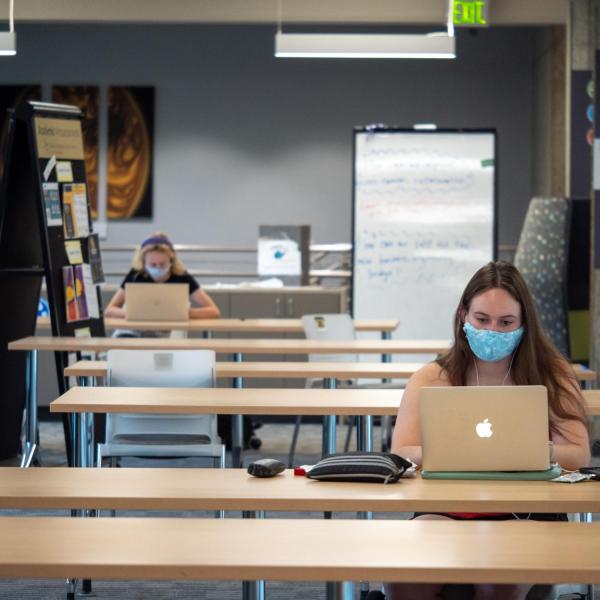 Students, staff and faculty, all wearing facial coverings and practicing proper social distancing protocols, study at the Engineering Center on the first day of the 2020 Fall semester on the CU Boulder Campus. (Photo by Glenn Asakawa/University of Colorado)