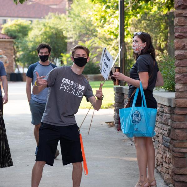 Volunteers display their CU Pride. Parents and first year students at CU Boulder move into the residence halls on Monday, August 17, 2020. They adhered to facial covering and social distancing policies. (Photo by Glenn Asakawa/University of Colorado)