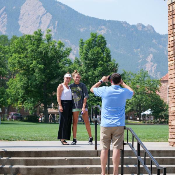A family takes a photo at Farrand Field during Move-In on Tuesday, Aug. 17, 2021. (Photo by Glenn Asakawa/University of Colorado)