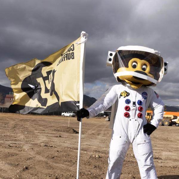 Mascot Chip plants the Colorado Buffaloes flag at the new aerospace building grounds