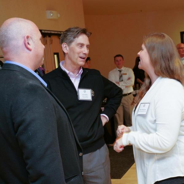 Interim Dean of College of Arts and Sciences Dean White chats with award recipient Matthew McQueen and Mary McQueen.