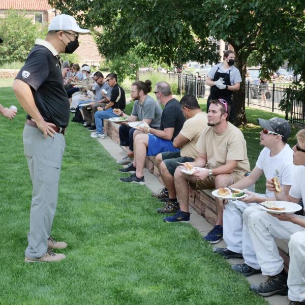 Vice Chancellor for Infrastructure and Safety David Kang sits with FacMan employees at Buffs Back Together.