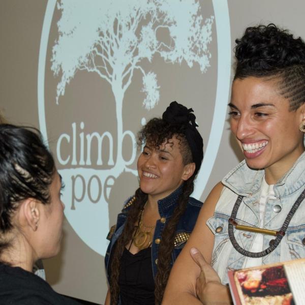 Alixa and Namia, Climbing PoeTree, talk with fans after a packed performance that wrapped up the Front Range Eco-Social Solutions Conference. Photo from the Environmental Center.