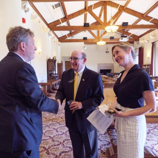 Chancellor Phil DiStefano and AVC Kirsten Schuchman, right, greet a member of the EU delegation.