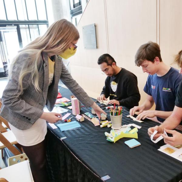 An employee assists students with an activity at the CU Art Museum