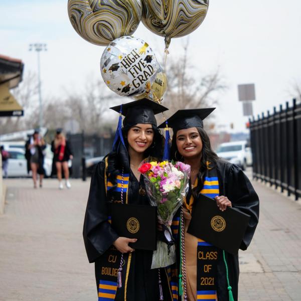 Adilene Garcia Aniles, left, and Neha Byati show off their celebratory accessories during CU Boulder’s Graduate Appreciation Days events. (Photo by Glenn Asakawa/University of Colorado)