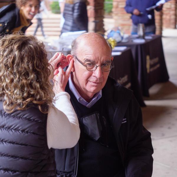 Chancellor Phil DiStefano gets acupuncture ear seeds placed on pressure points in his ear during the Health Hut event. (Photo by Glenn Asakawa/University of Colorado)