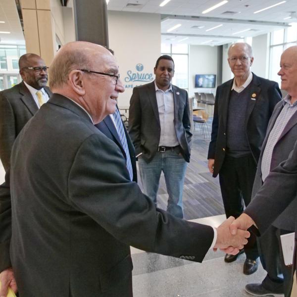 CU Boulder Chancellor Phil DiStefano shakes hands with Congressman Donald Norcross, New Jersey. In the background are CU Boulder’s Brian Argrow; U.S. Rep. Joe Neguse; Congressman Bill Foster, Illinois; and Congressman Jerry McNerney, California.