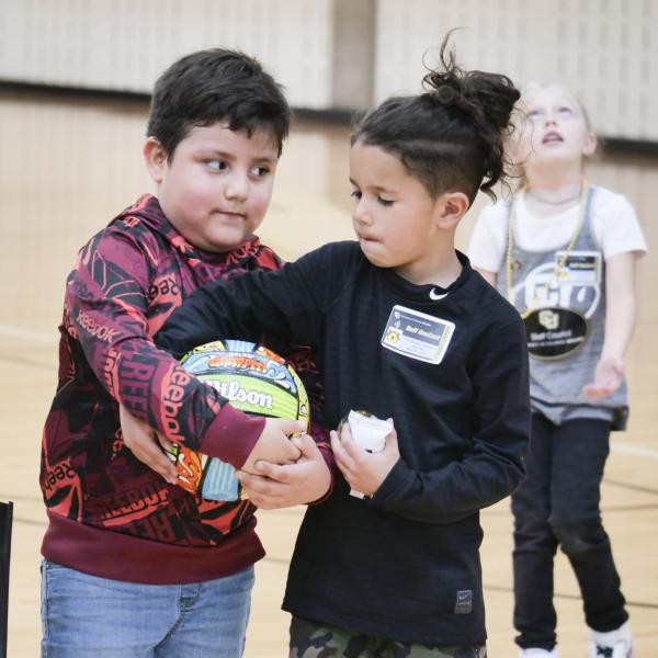 A friendly tug-of-war occurs at Campus Kids Day. (Photo by Casey A. Cass/University of Colorado)